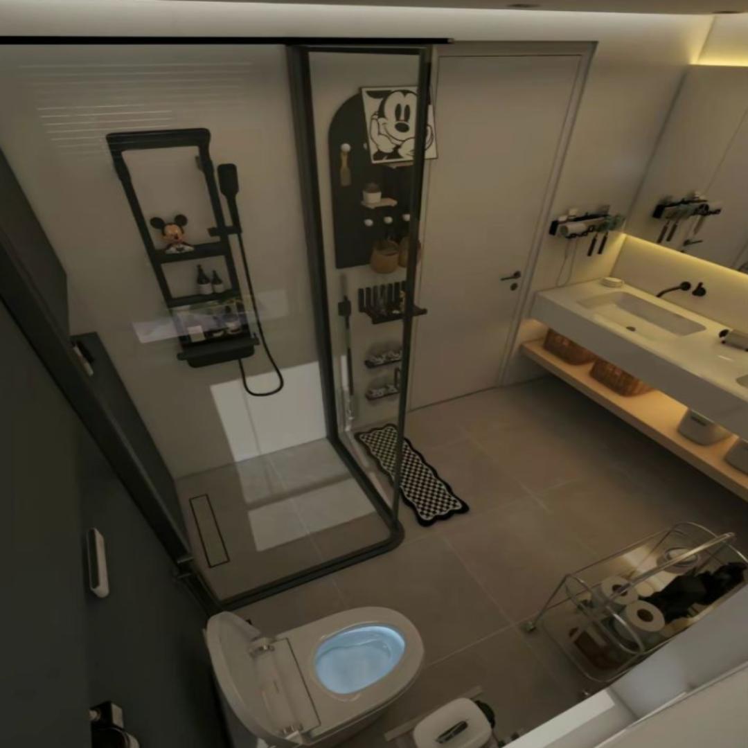 Modern small bathroom with custom vanity, glass shower, and wall-mounted organizer—showcasing efficient layout and stylish storage for compact spaces.