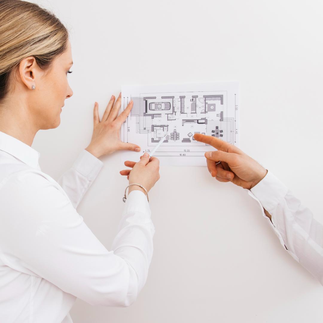 Contractors reviewing bathroom layout plan for vanity installation