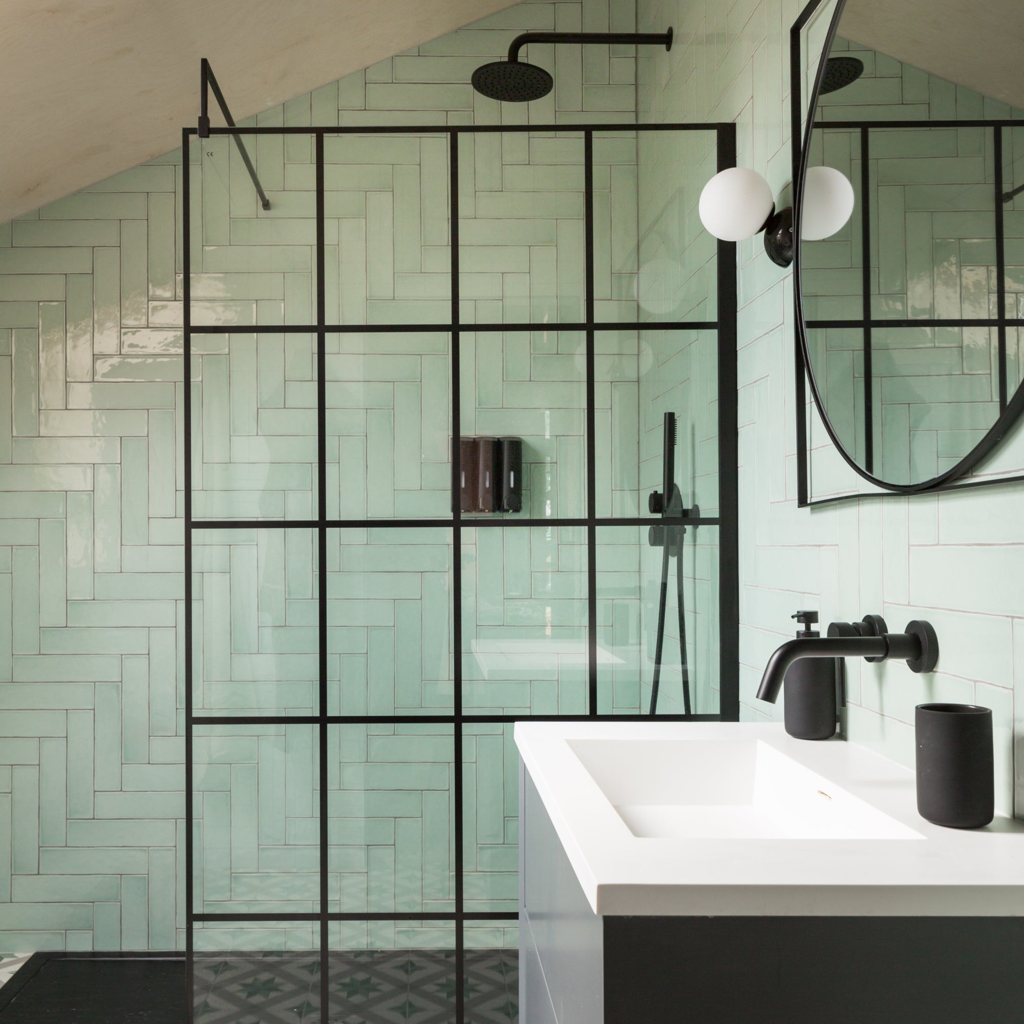 Modern bathroom with green subway tiles