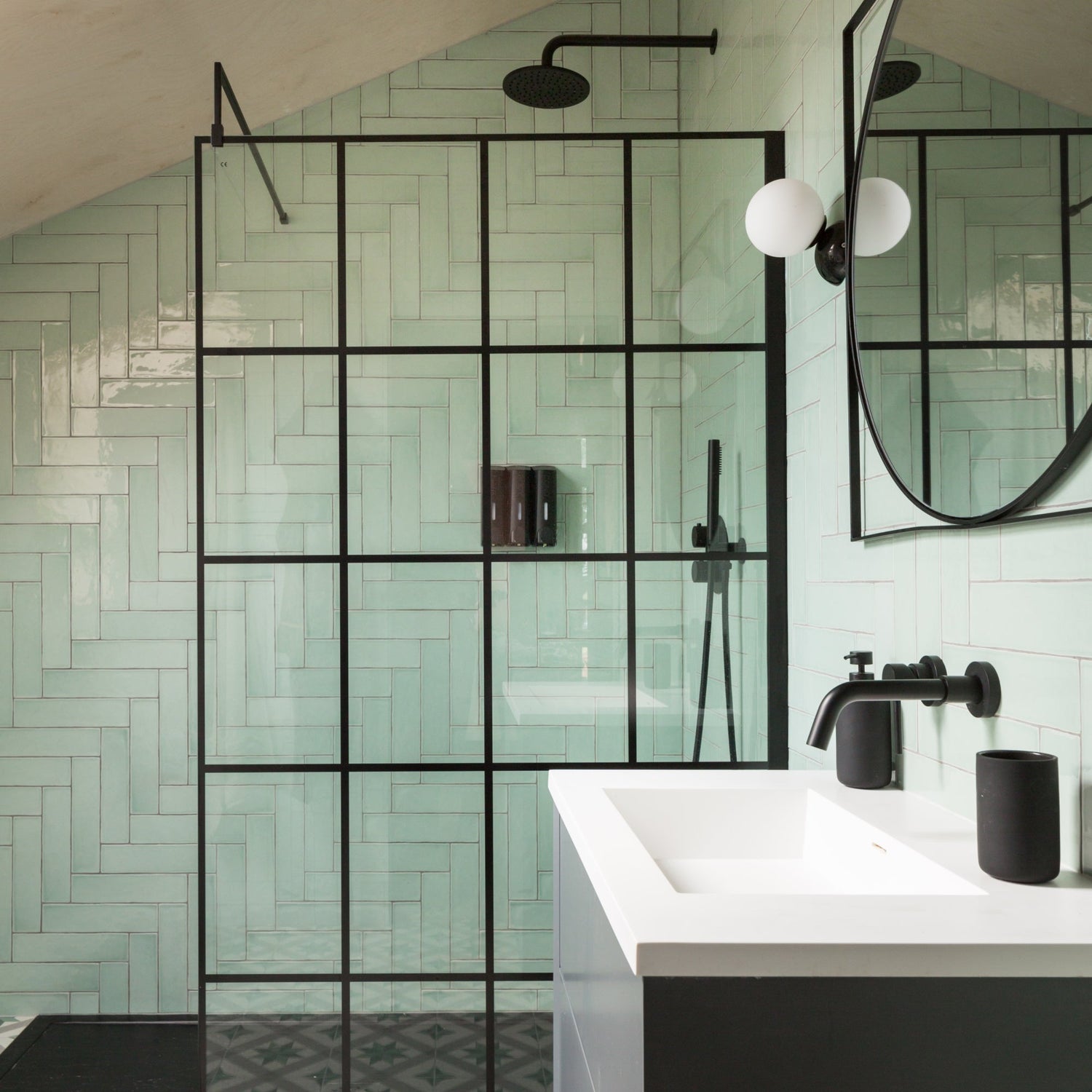 Modern bathroom with green subway tiles